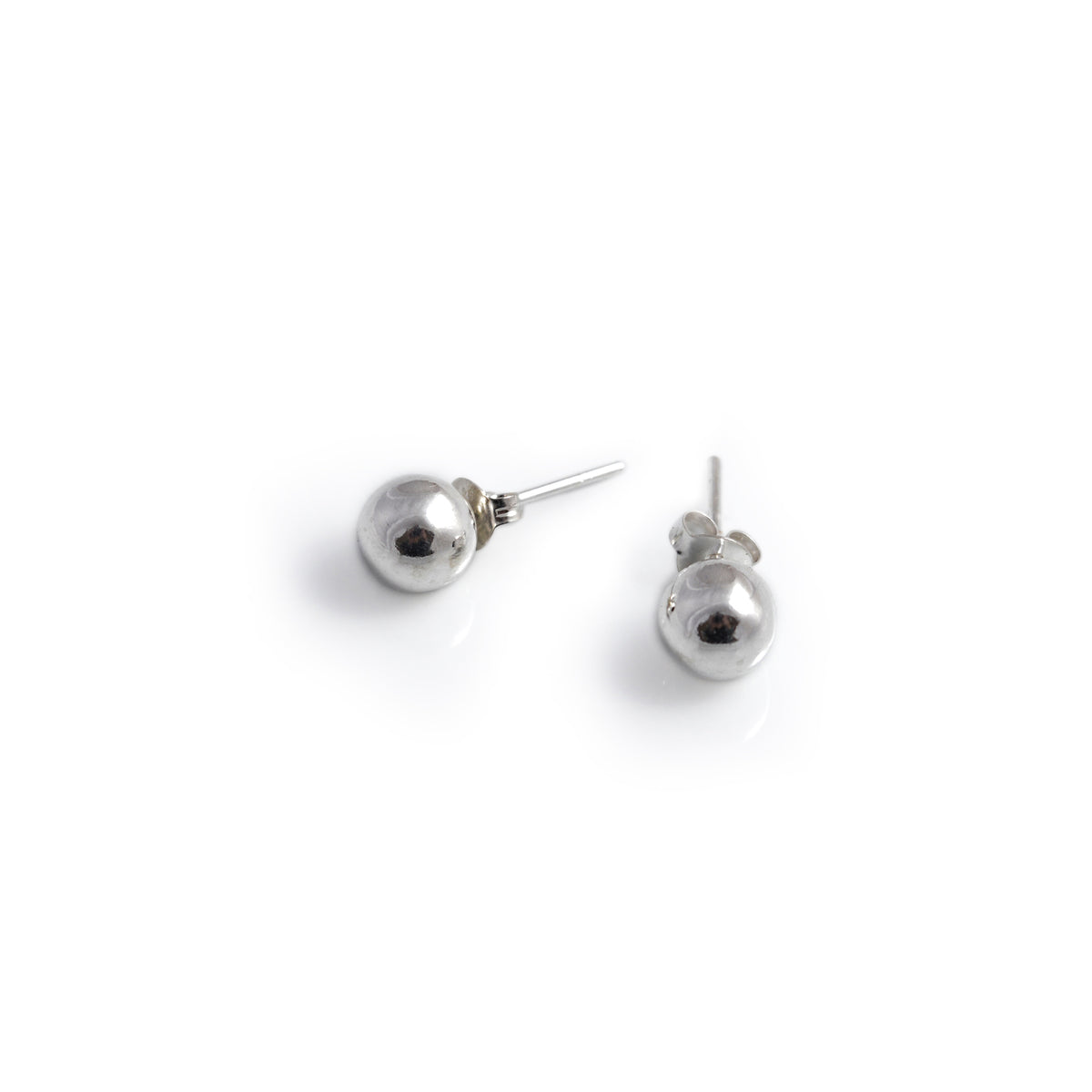 Pair of silver ball earrings on a white background