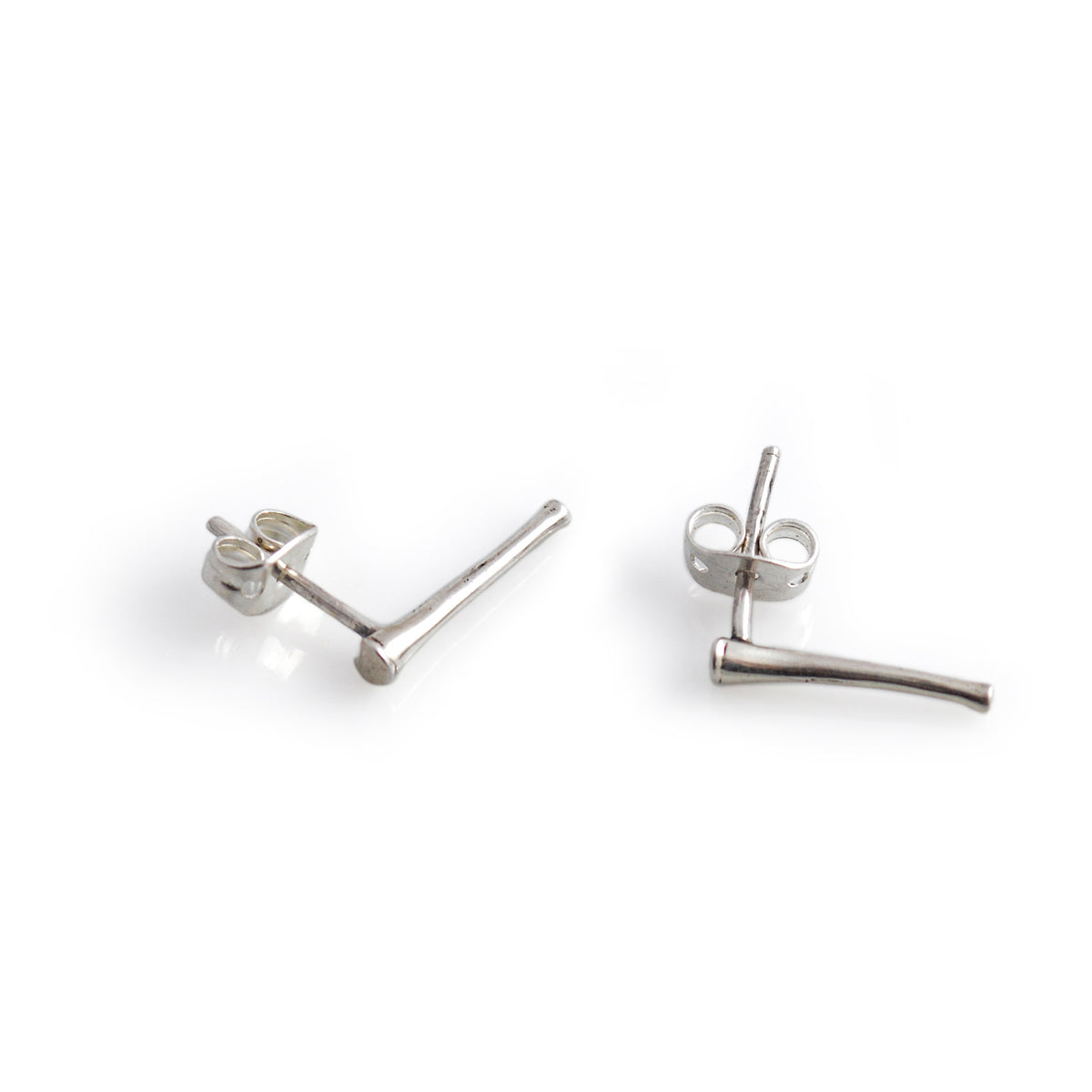 Pair of silver stud earrings on a white background