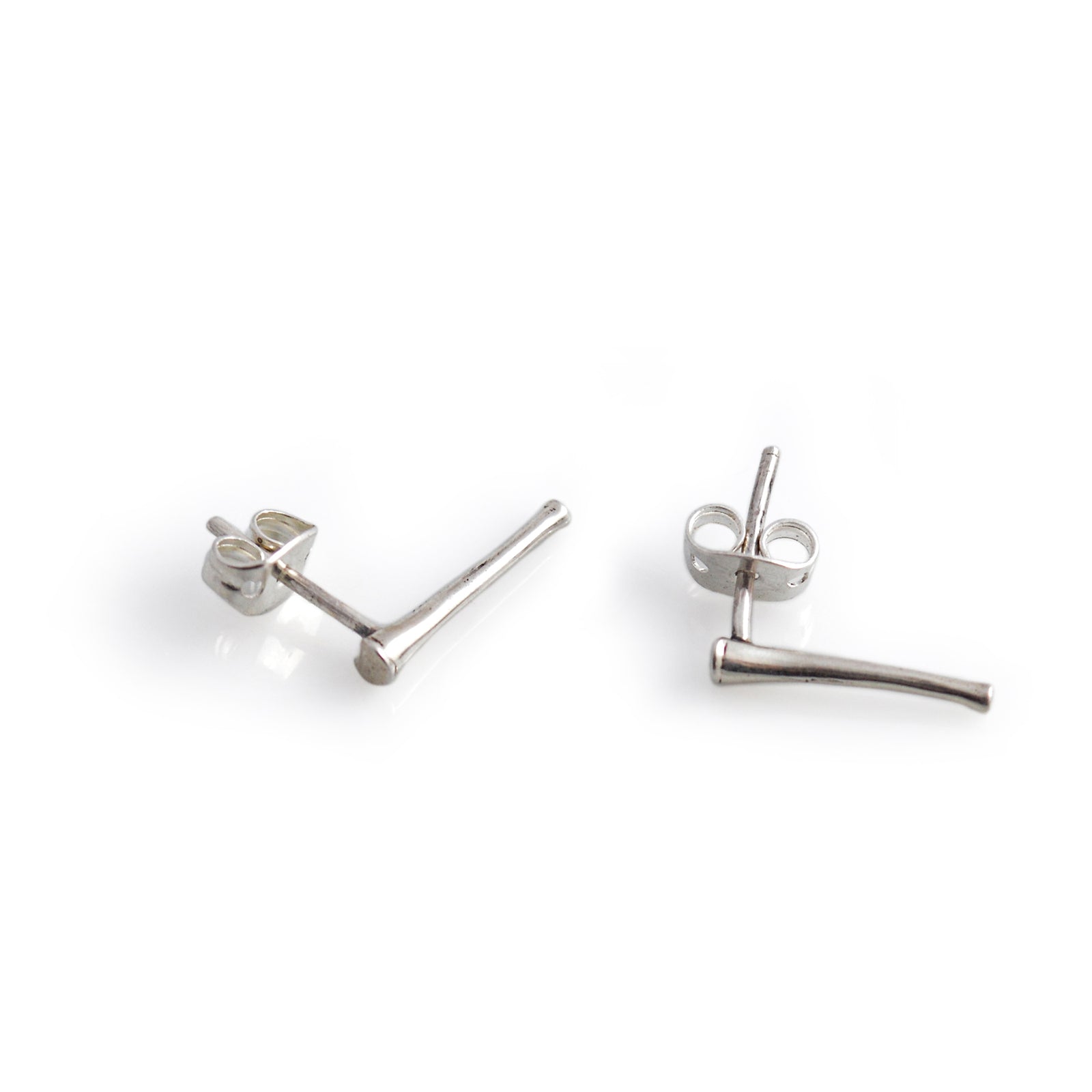 Pair of silver stud earrings on a white background